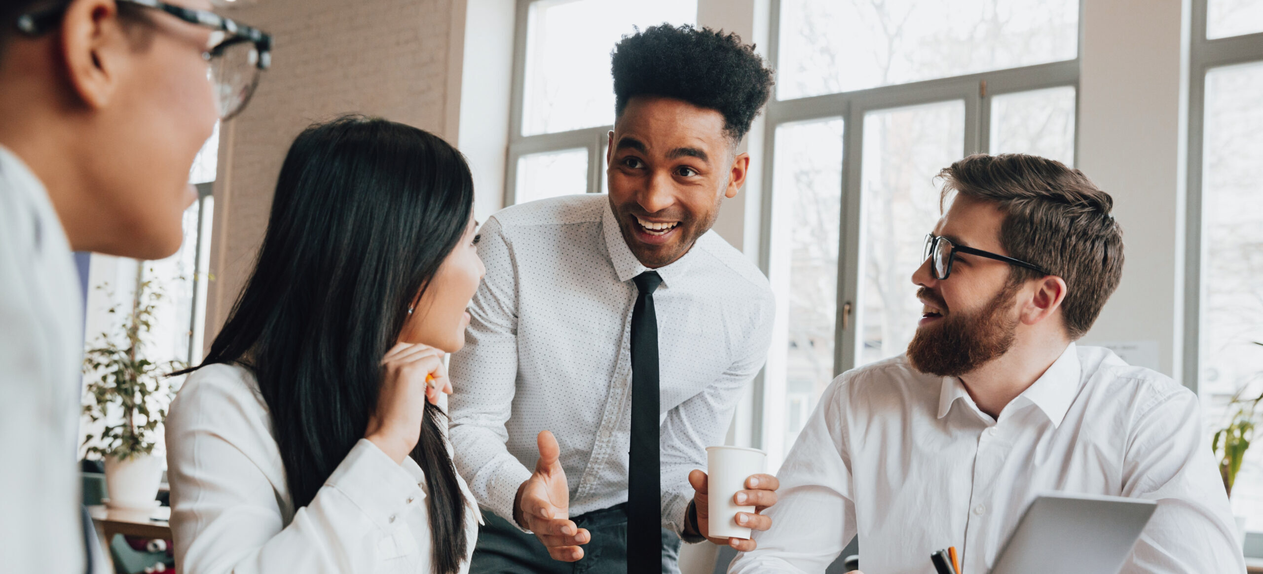 Effective team leader joking with the employees.