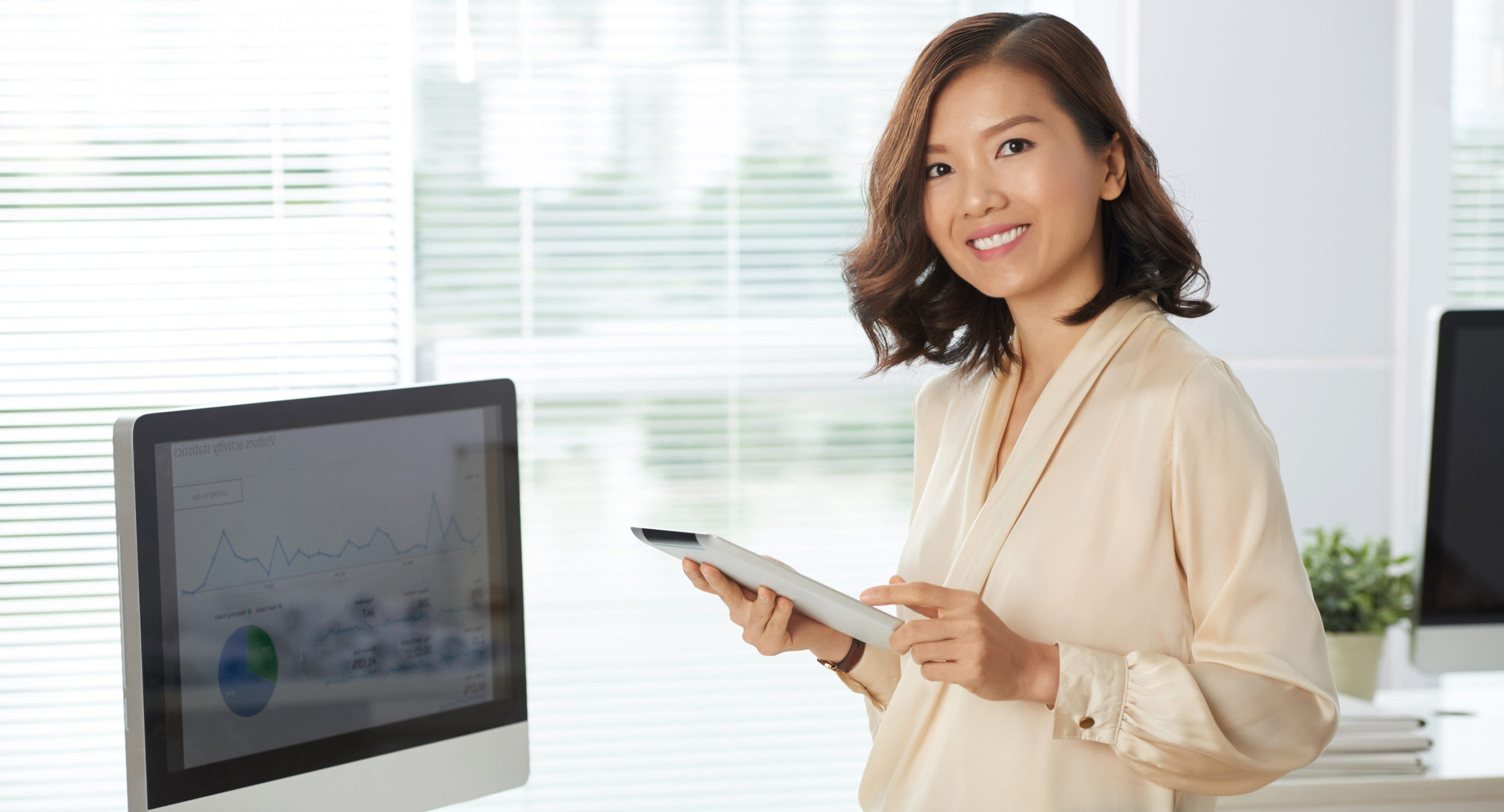 Young woman conducts statistical process control in office and analyzes graphs